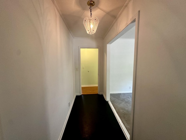 corridor featuring ornamental molding and baseboards
