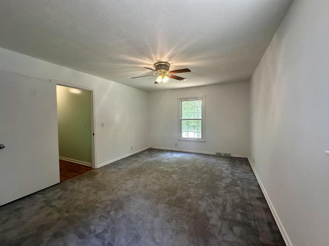 unfurnished room with carpet flooring, visible vents, baseboards, and ceiling fan