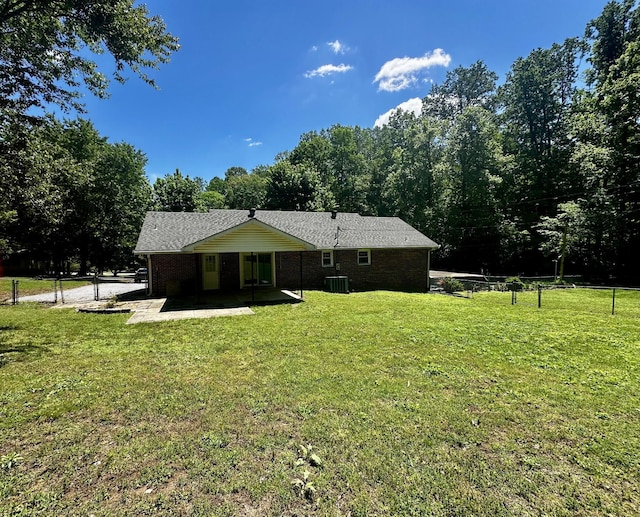 rear view of property with a patio, fence, and a lawn