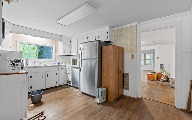 4101 Taft Hwy, Signal Mountain, TN 37377 - kitchen featuring hardwood / wood-style flooring, stainless steel appliances, ornamental molding, white cabinetry, and light countertops