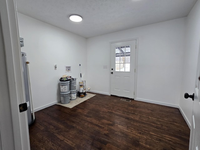 interior space featuring baseboards, visible vents, and wood finished floors