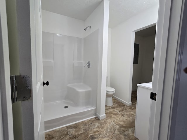 bathroom with walk in shower, toilet, electric panel, and baseboards