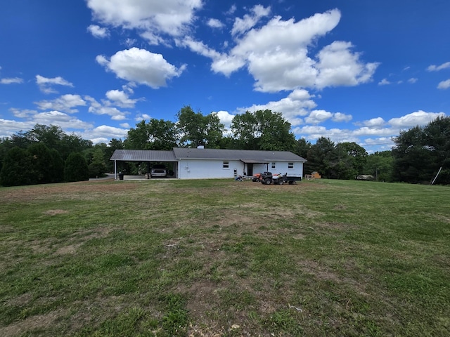 exterior space featuring a front lawn and a carport
