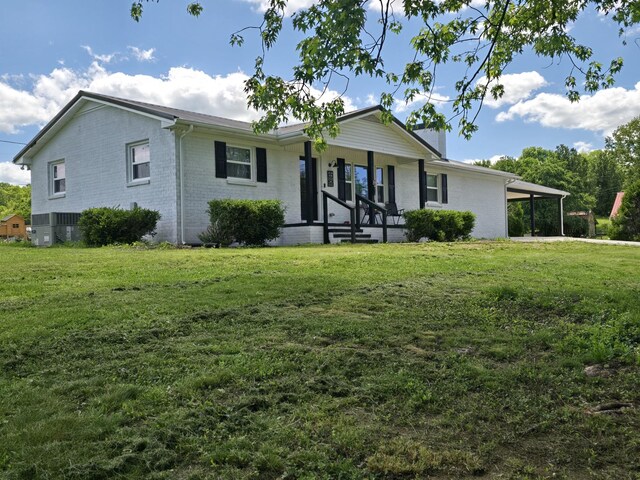 single story home with a porch, a front lawn, and brick siding