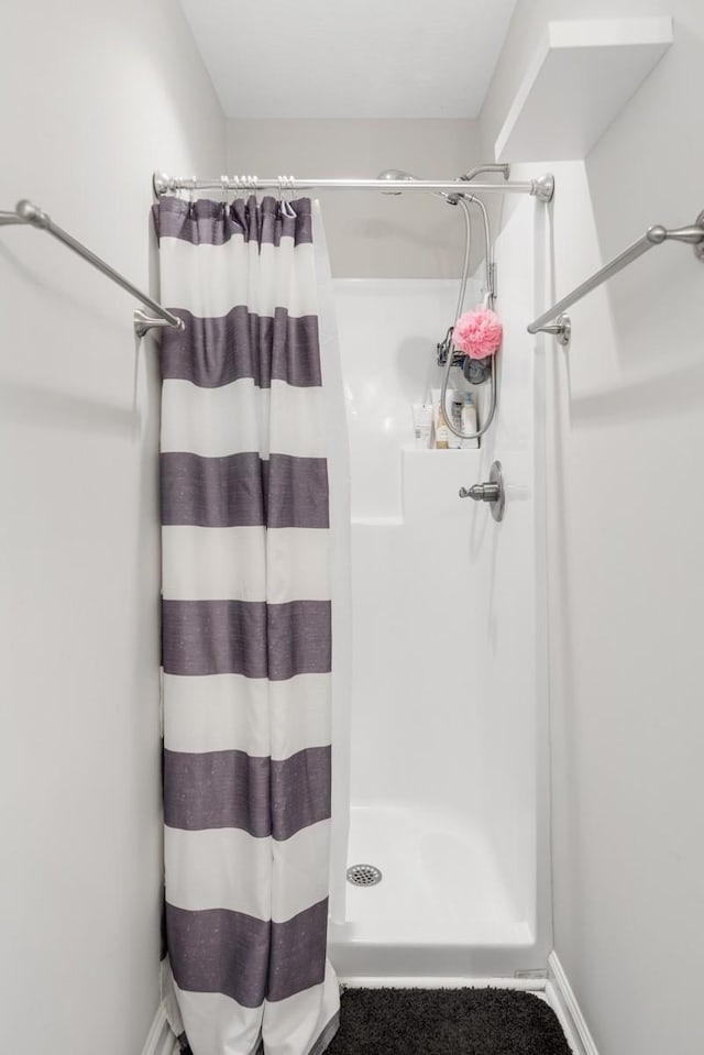 full bath with a shower stall