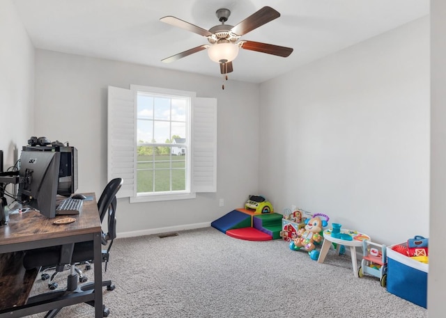 office space featuring ceiling fan, carpet flooring, and baseboards