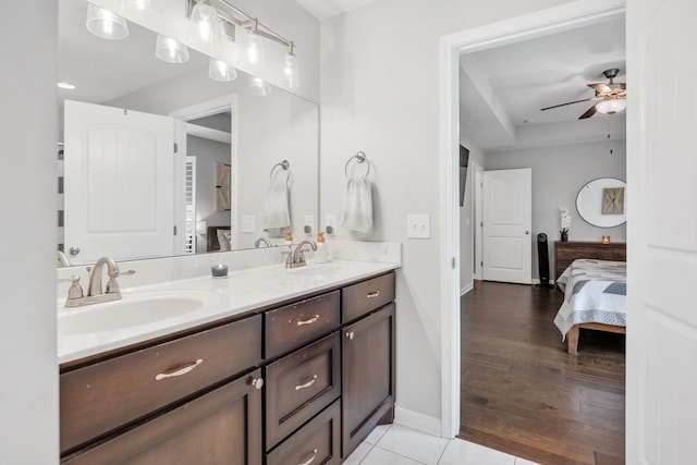 bathroom with a sink, ceiling fan, double vanity, and ensuite bath