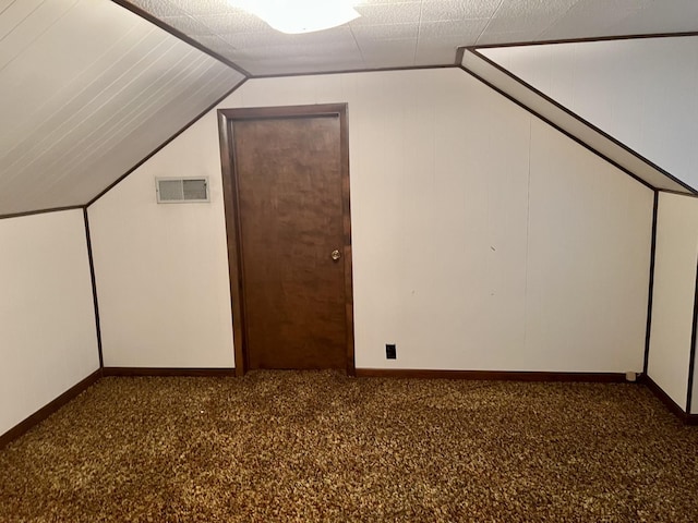 bonus room featuring baseboards, visible vents, carpet floors, and vaulted ceiling