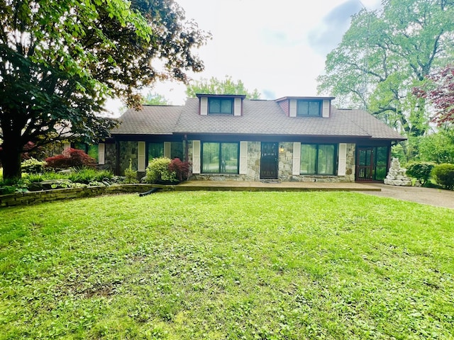 view of front of property with a front lawn and stone siding