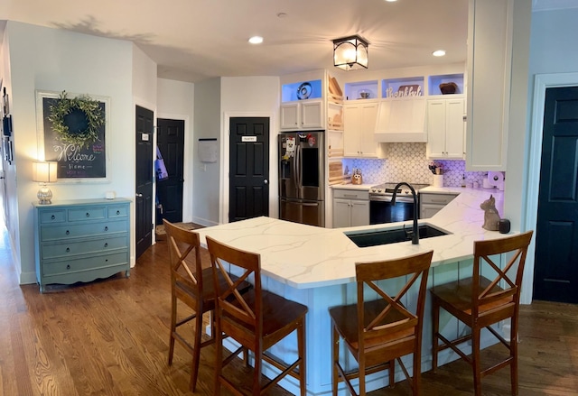605 Nevins Pl, Nolensville, TN 37135 - kitchen with appliances with stainless steel finishes, a sink, light stone countertops, a peninsula, and white cabinets