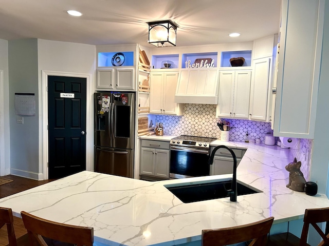 605 Nevins Pl, Nolensville, TN 37135 - kitchen with appliances with stainless steel finishes, custom range hood, a sink, light stone counters, and recessed lighting