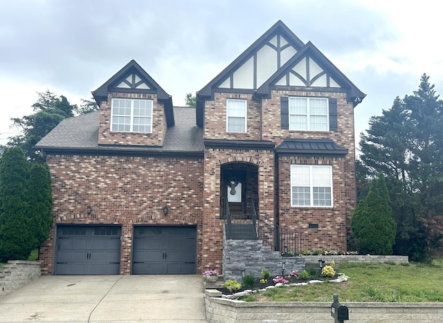 605 Nevins Pl, Nolensville, TN 37135 - tudor-style house featuring brick siding, an attached garage, and driveway