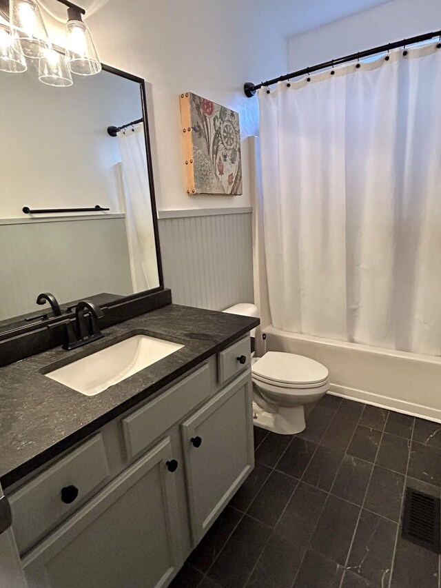 605 Nevins Pl, Nolensville, TN 37135 - bathroom featuring shower / bath combo with shower curtain, toilet, a wainscoted wall, vanity, and tile patterned floors