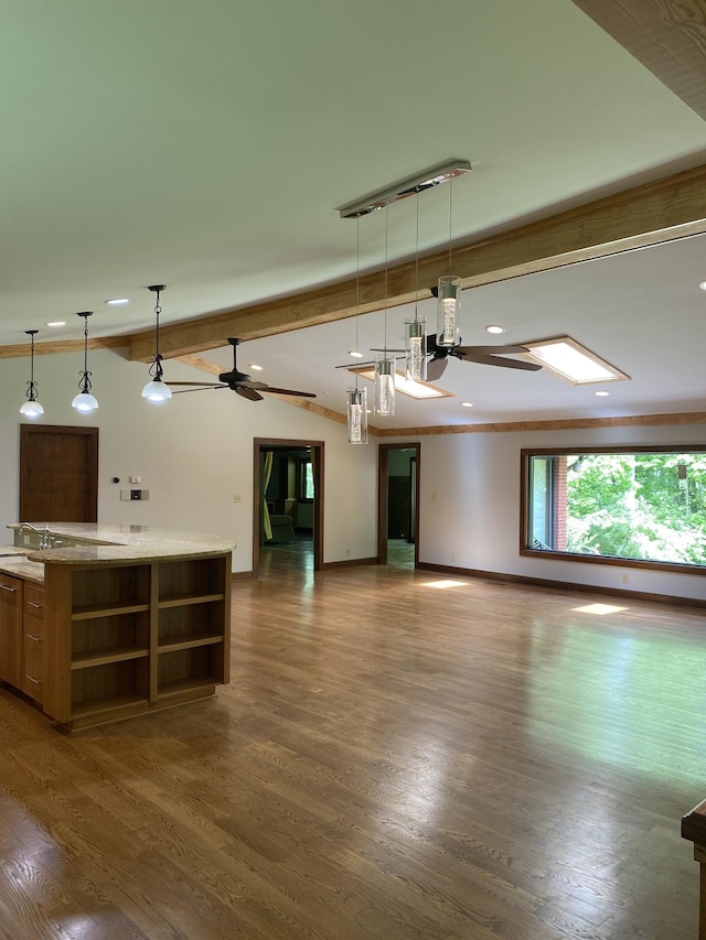 unfurnished living room featuring a ceiling fan, recessed lighting, baseboards, beamed ceiling, and dark wood-style floors