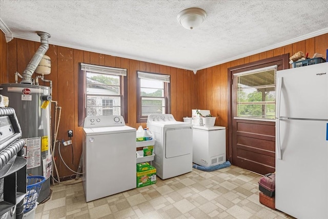 laundry room with washing machine and clothes dryer, light floors, laundry area, and gas water heater