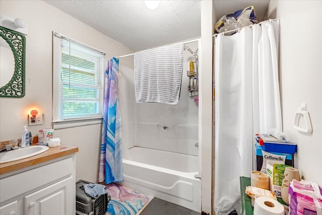 bathroom featuring shower / bathtub combination with curtain, vanity, and a textured ceiling