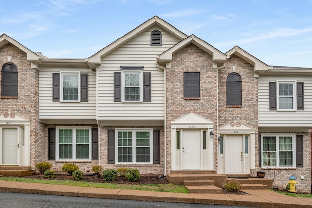 view of property with brick siding