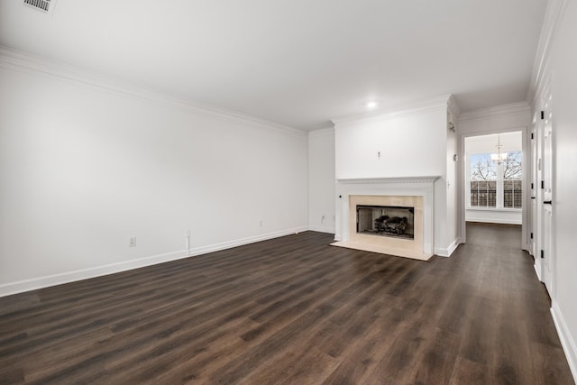 unfurnished living room with ornamental molding, dark wood-type flooring, visible vents, baseboards, and a fireplace with flush hearth