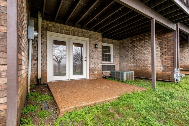 exterior space featuring central air condition unit and brick siding