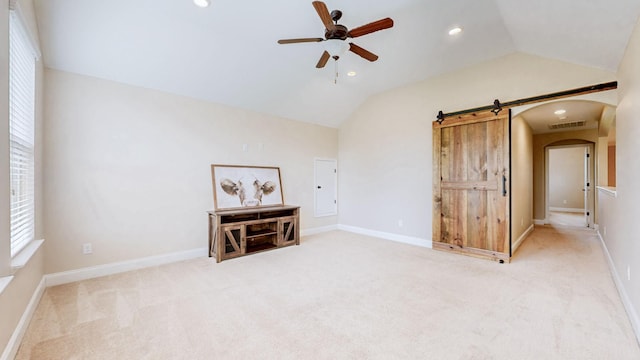 carpeted empty room featuring a ceiling fan, lofted ceiling, visible vents, and arched walkways