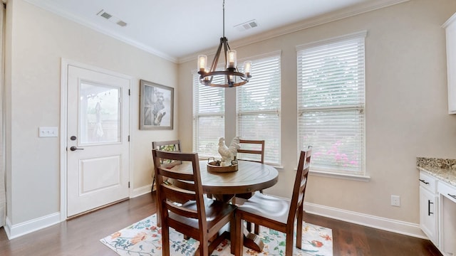 dining room with a chandelier, ornamental molding, dark wood-style floors, and visible vents