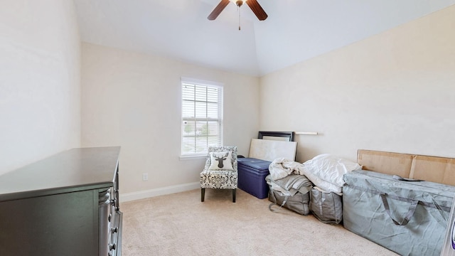 living area with a ceiling fan, light carpet, baseboards, and lofted ceiling