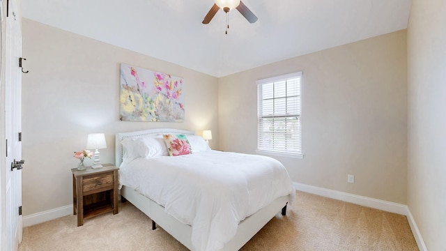 carpeted bedroom featuring baseboards and a ceiling fan