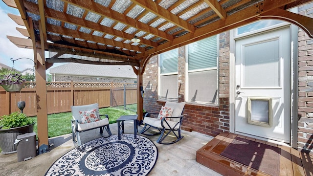 view of patio featuring a pergola and fence