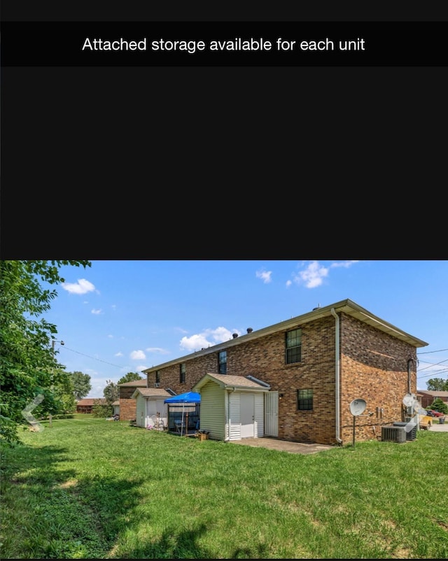 365 Peabody Dr, Clarksville, TN 37042 - back of house featuring a yard, a shed, an outdoor structure, and brick siding