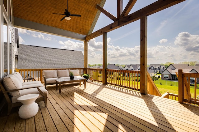 wooden terrace with ceiling fan, an outdoor living space, and a residential view