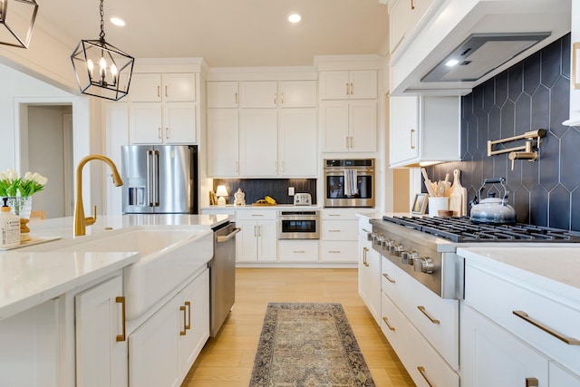 kitchen featuring a sink, backsplash, appliances with stainless steel finishes, custom range hood, and recessed lighting