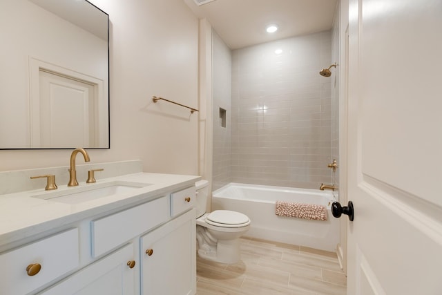 bathroom featuring toilet,  shower combination, vanity, and recessed lighting