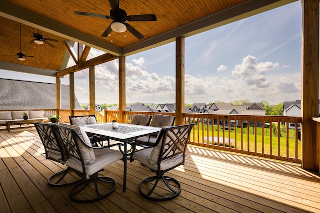 deck featuring a yard, outdoor dining space, ceiling fan, an outdoor hangout area, and a residential view