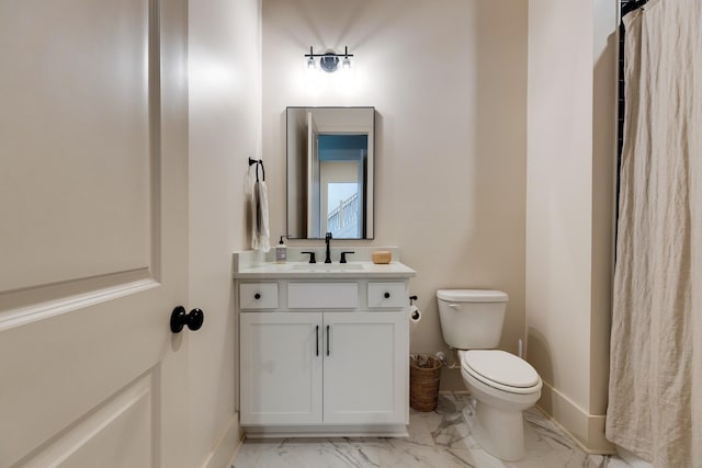 full bath with vanity, toilet, baseboards, and marble finish floor