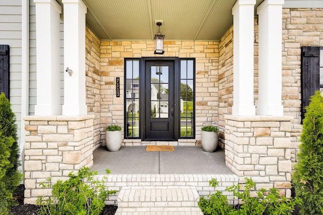 property entrance featuring a porch and stone siding