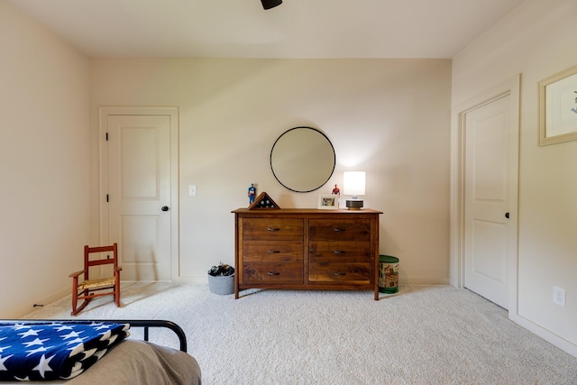 carpeted bedroom featuring baseboards and a ceiling fan