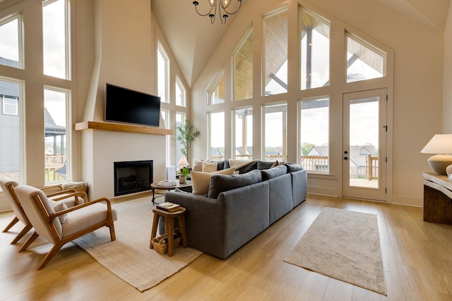 living room featuring a high ceiling, a fireplace, and plenty of natural light