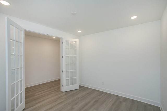 unfurnished room with recessed lighting, baseboards, french doors, and wood finished floors