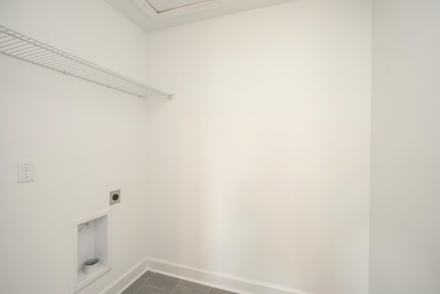 laundry area featuring baseboards, dark tile patterned floors, laundry area, and electric dryer hookup