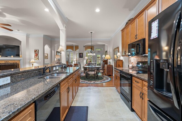 1230 Chickadee Cir, Hermitage, TN 37076 - kitchen with a sink, brown cabinetry, arched walkways, black appliances, and ornamental molding