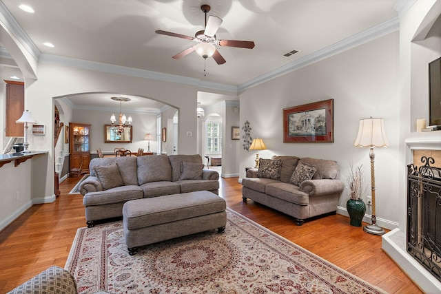 1230 Chickadee Cir, Hermitage, TN 37076 - living area with ceiling fan with notable chandelier, arched walkways, light wood-type flooring, and baseboards