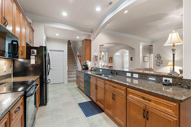 1230 Chickadee Cir, Hermitage, TN 37076 - kitchen featuring visible vents, a sink, brown cabinets, arched walkways, and black appliances