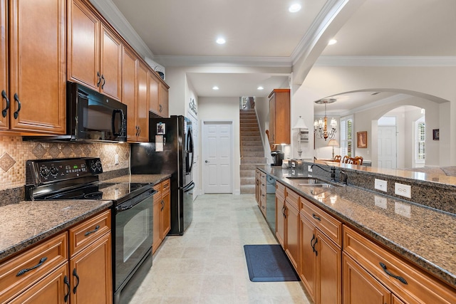 1230 Chickadee Cir, Hermitage, TN 37076 - kitchen featuring brown cabinets, a sink, arched walkways, black appliances, and tasteful backsplash