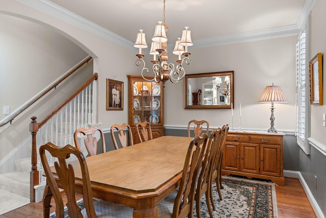 1230 Chickadee Cir, Hermitage, TN 37076 - dining room featuring a notable chandelier, crown molding, light wood-type flooring, and stairway