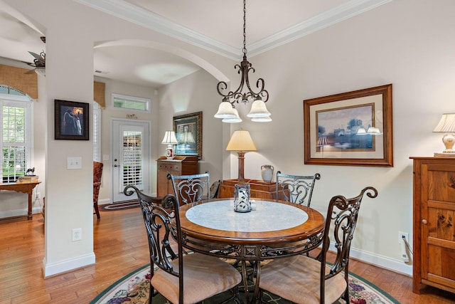 1230 Chickadee Cir, Hermitage, TN 37076 - dining space with baseboards, light wood-style floors, crown molding, and arched walkways
