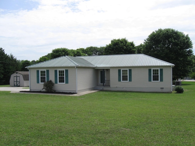 224 Gaines Cir, Estill Springs, TN 37330 - ranch-style house with a front lawn, an outbuilding, metal roof, and a storage unit