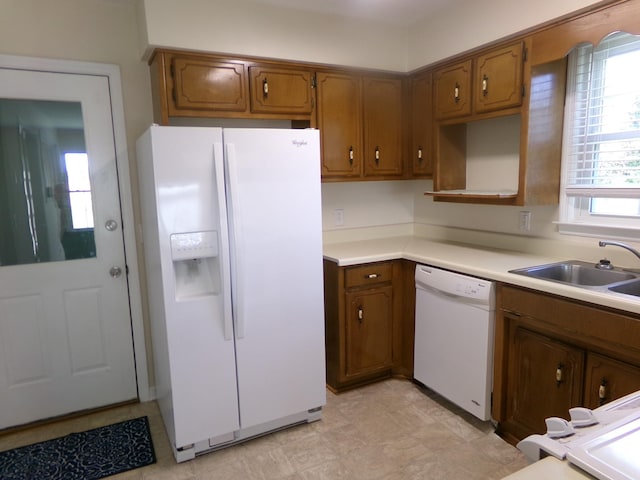 224 Gaines Cir, Estill Springs, TN 37330 - kitchen with white appliances, brown cabinets, a sink, and light countertops