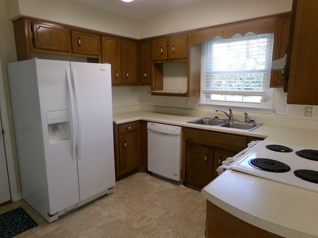 224 Gaines Cir, Estill Springs, TN 37330 - kitchen with white appliances, a sink, brown cabinets, and light countertops