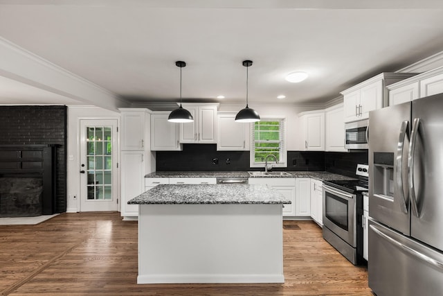 3103 Lakeland Dr, Nashville, TN 37214 - kitchen featuring white cabinetry, stainless steel appliances, a brick fireplace, and a sink