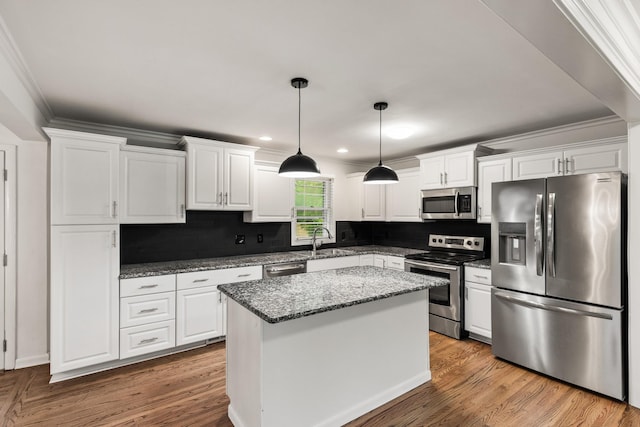 3103 Lakeland Dr, Nashville, TN 37214 - kitchen with a sink, white cabinets, backsplash, appliances with stainless steel finishes, and a kitchen island